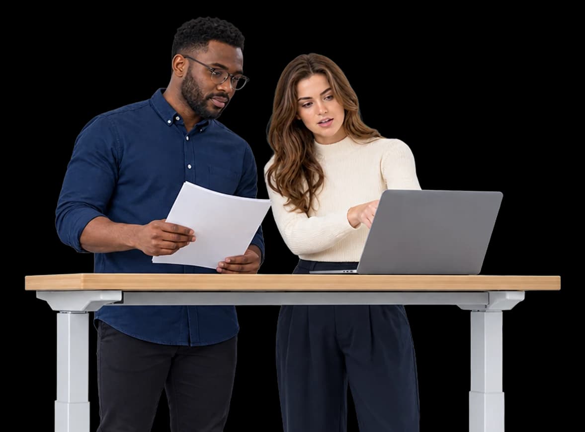 Two engineers review model outputs together at a shared high desk.