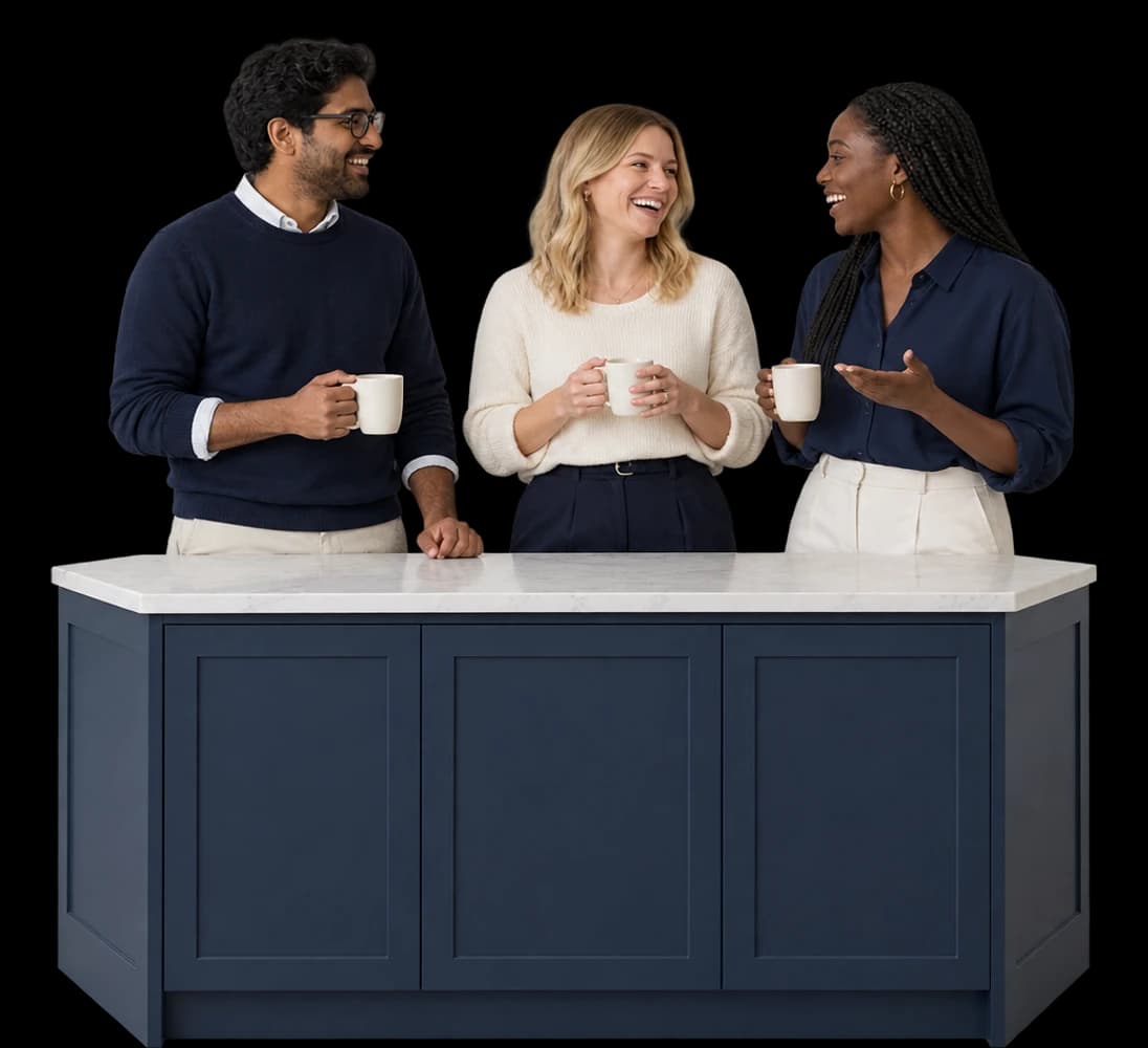 Three founders talk over coffee around their office kitchen island.