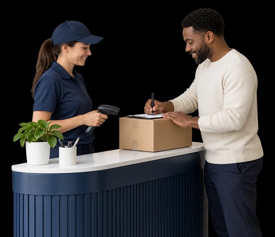 An office manager signs for a delivery at a reception desk.