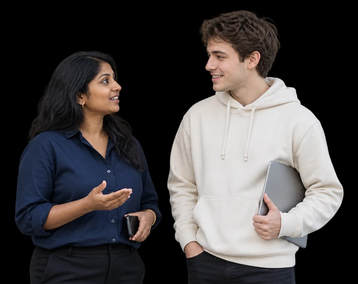A trust and safety lead and an engineer talk while holding a phone and laptop.