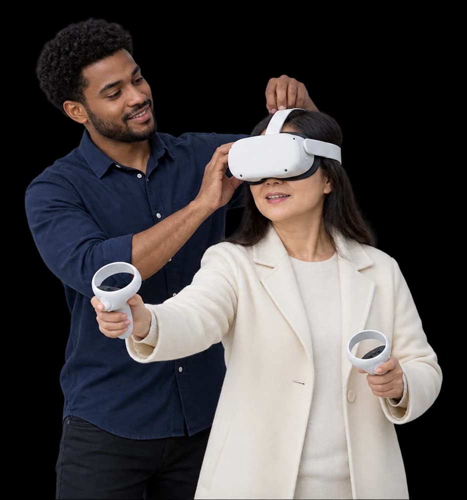 A demo lead adjusts a headset on a visitor holding a hand controller.
