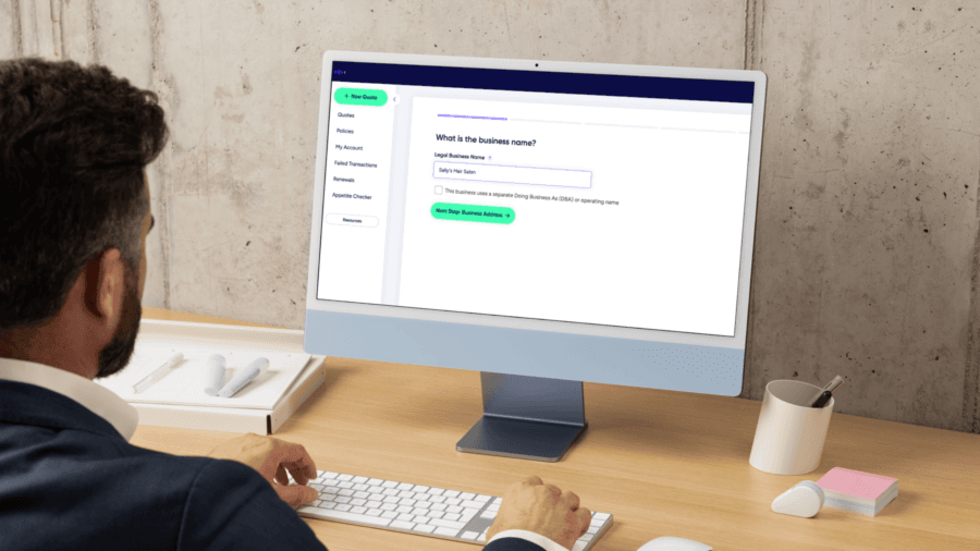 Coterie's official marketing image showing an agent beginning a new quote with an empty legal-business-name field in the Coterie dashboard.